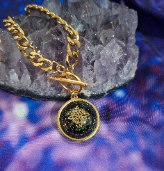 COLGANTE NUDO DE BRUJAS DE ACERO Y TURMALINA.