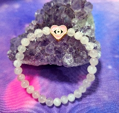 PULSERA DE CUARZO ROSA CON OJO TURCO DE ACERO INOXIDALE